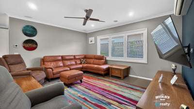 Spacious living area features contemporary furnishings and vibrant decor, perfect for relaxation and entertaining.