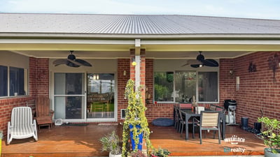 Spacious outdoor area with a covered patio, perfect for entertaining and enjoying the serene backyard.