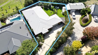 Spacious property featuring a lush yard, pool, and ample parking with a functional layout.