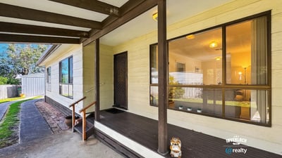 This inviting home features a spacious porch, perfect for relaxation and outdoor gatherings.