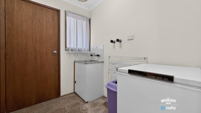 Functional laundry space featuring ample storage and convenient layout for efficient household management.