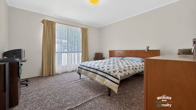 Spacious bedroom featuring large windows, ample natural light, and practical storage solutions for everyday convenience.