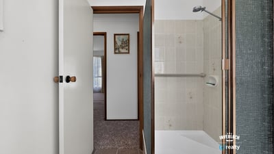 This bathroom features a convenient layout with practical finishes just steps from the living area.