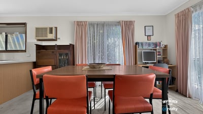 Bright dining area featuring a spacious table and large windows that invite natural light.