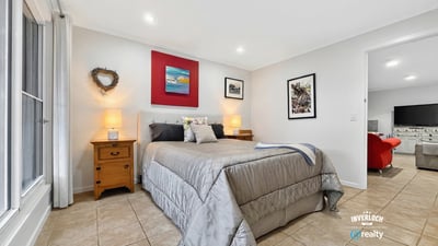 Spacious bedroom featuring modern decor, natural light, and ample storage for a comfortable living experience.