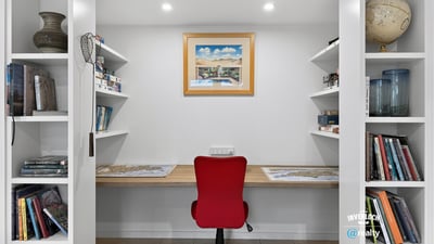 Bright and functional office space with built-in shelving, perfect for productivity and organization.