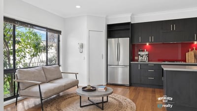 Modern kitchen and inviting living area with natural light, perfect for comfortable daily living.