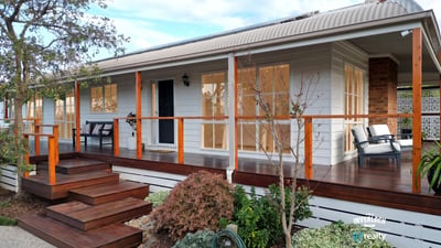 Discover a beautifully designed home featuring a welcoming porch and well-maintained landscaping, perfect for outdoor enjoyment.