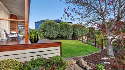 Inviting outdoor space with landscaped garden and seating area, perfect for relaxation and entertaining.
