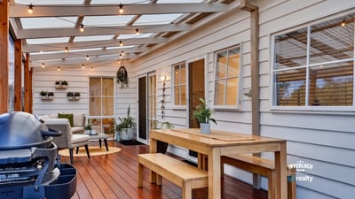 Bright, inviting outdoor space features a dining area and seating, perfect for entertaining year-round.