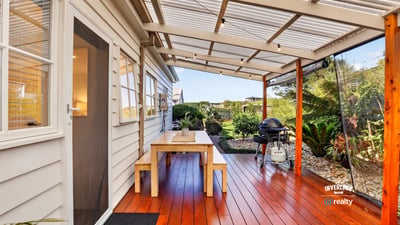 Enjoy outdoor living on this spacious deck, surrounded by lush greenery and perfect for entertaining.