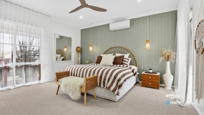 Bright and spacious bedroom featuring neutral tones, a comfortable bed, and inviting decor for relaxation.