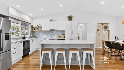 Bright, open kitchen with modern appliances, spacious island, and inviting dining area for entertaining.
