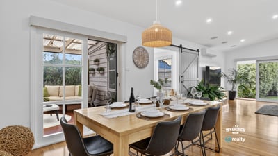 Spacious dining area with natural light, leading to a cozy outdoor retreat for entertaining.