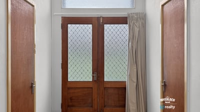 Bright entryway featuring distinctive glass doors and abundant natural light, welcoming you into the home.
