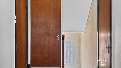 This inviting upper hallway features ample natural light and access to multiple rooms for convenience.