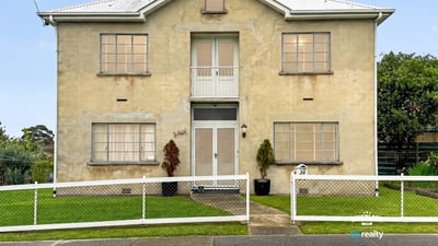 Spacious two-story residence featuring distinct architecture and ample outdoor space for relaxation and activities.
