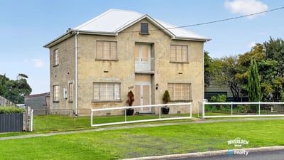 Spacious two-story home featuring ample yard space and unique architectural details in a quiet neighborhood.