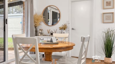 Bright dining area featuring natural light, modern decor, and easy access to outdoor space.