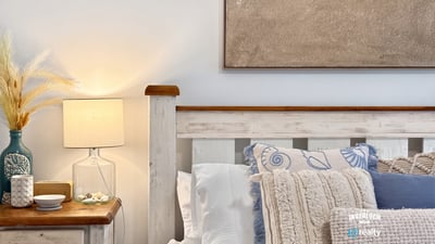 Cozy bedroom featuring soft textiles and beach-inspired decor, perfect for relaxation and restful nights.