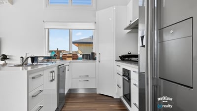 Bright and modern kitchen featuring sleek cabinetry and ample counter space, perfect for culinary enthusiasts.