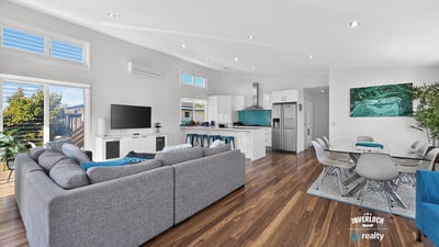 Modern open-plan living space with abundant natural light, featuring a spacious kitchen and inviting entertainment area.