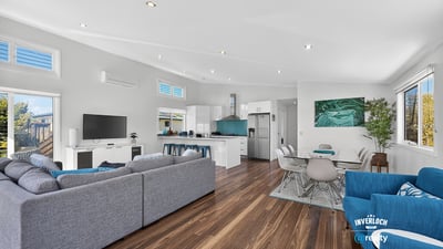 Modern open-concept living space with natural light, sleek design, and inviting atmosphere for family gatherings.