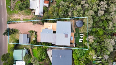 Spacious property surrounded by greenery, featuring ample outdoor space and convenient access to main roads.
