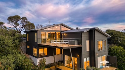 Contemporary home with expansive windows, offering breathtaking views and seamless integration with nature.