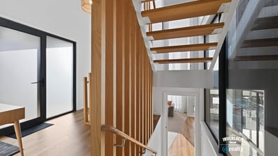 Contemporary open staircase showcases modern design, enhancing the home's inviting and spacious atmosphere.