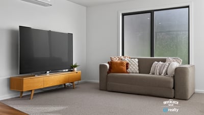 Bright and spacious living area featuring modern furnishings and large windows for ample natural light.