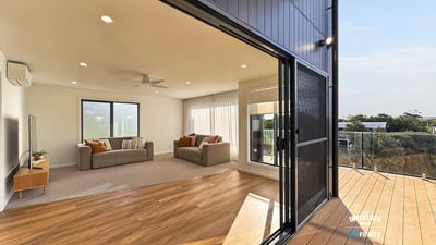 Bright, open living area seamlessly connects to an inviting outdoor deck, perfect for entertaining and relaxation.