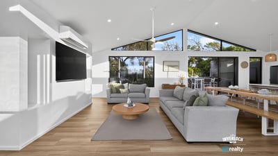 Bright and airy living space with large windows offering stunning views and seamless indoor-outdoor flow.