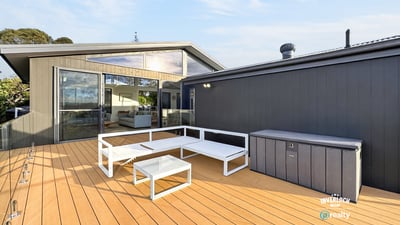 Spacious outdoor deck with modern seating, perfect for entertaining and enjoying views in a contemporary setting.