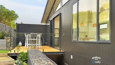 Modern home featuring an expansive deck, perfect for outdoor dining and enjoying scenic views.