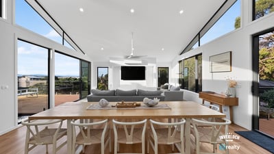 Contemporary open-plan living space featuring abundant natural light and stunning views, ideal for entertaining.