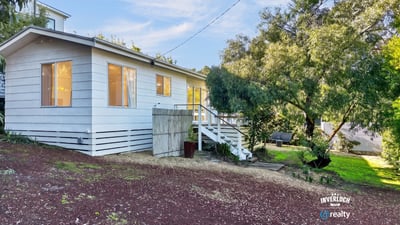 This inviting home features ample natural light, a spacious yard, and a peaceful setting near nature.