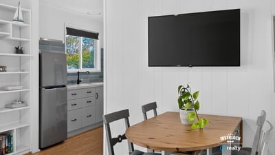 Bright open kitchen and dining area with modern appliances and inviting natural light for casual gatherings.