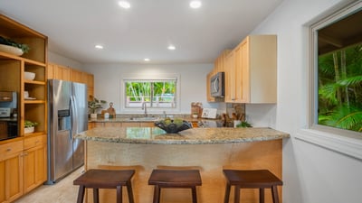 Modern kitchen featuring granite countertops, stainless steel appliances, and an inviting breakfast bar for casual dining.
