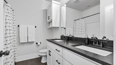 Upstairs Bathroom with Dual Vanity, Linin Closet, and Tub/Shower Combo