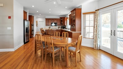Kitchen dining area features a ceiling fan, French doors to the deck and patio, and morning sun and sunrise views.