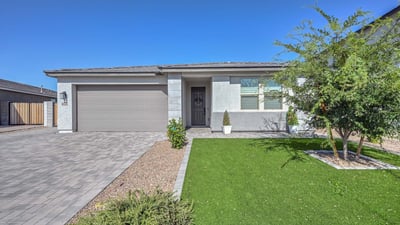 Crisp lines, designer stone accents, and easy-care desert landscaping define this newer construction Peoria home s refined curb appeal.