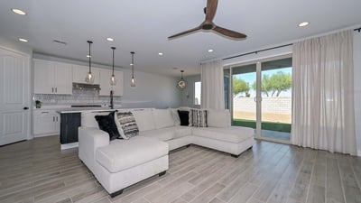 Experience seamless indoor-outdoor flow with this open layout, showcasing upgraded flooring, a statement fan, and sliders to the backyard.