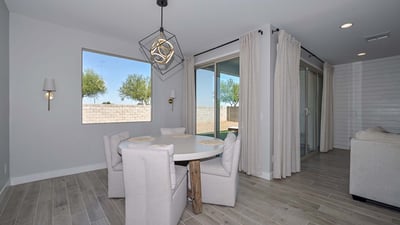 Tucked beside large windows and sliders, this intimate dining area invites sunlight and backyard views, perfect for morning meals or relaxed evenings.