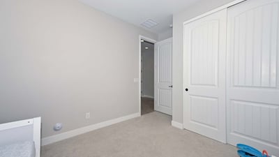 Featuring soft carpet and a large closet, this third bedroom is a blank canvas ready for personalization or practical use.