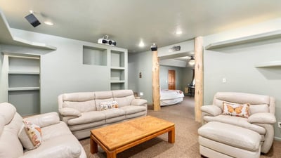 Lower-level living space with built-ins and open layout, ideal for lounging, hobbies, or overflow entertaining.