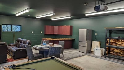 Versatile bonus room with built-in storage and durable finishes, ideal for recreation, hobbies, or gatherings. This adaptable space enhances everyday living in this Prescott log home.
