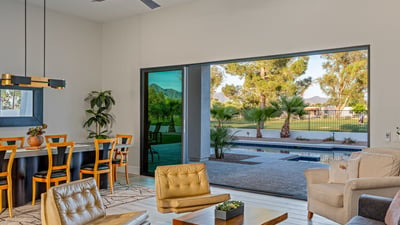 Expansive sliding glass doors connect the living room to the covered patio, showcasing seamless Scottsdale living.