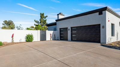 Updated garage doors add contemporary curb appeal to this Scottsdale property. The large driveway offers convenience and ample parking space.