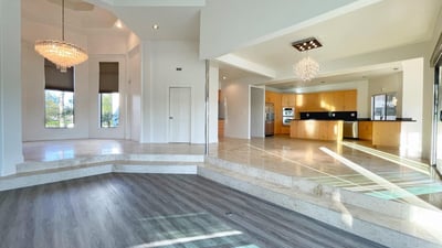 Inviting living room with contemporary finishes, expansive windows, and effortless connection to outdoor spaces and pool views.